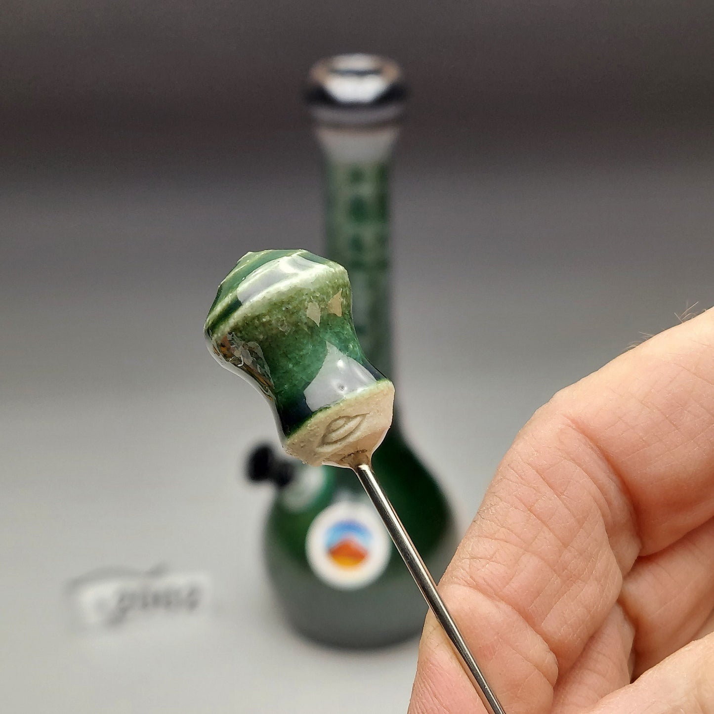 Matching poker for green and black ceramic water pipe side view